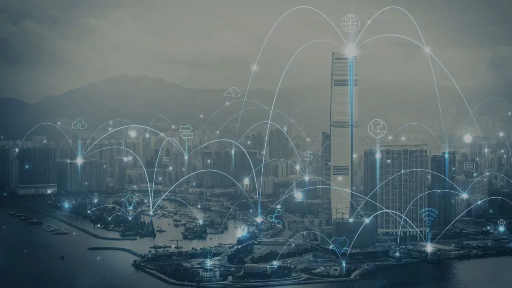Nighttime smart city skyline with digital network connections, representing Building Management Systems (BMS).